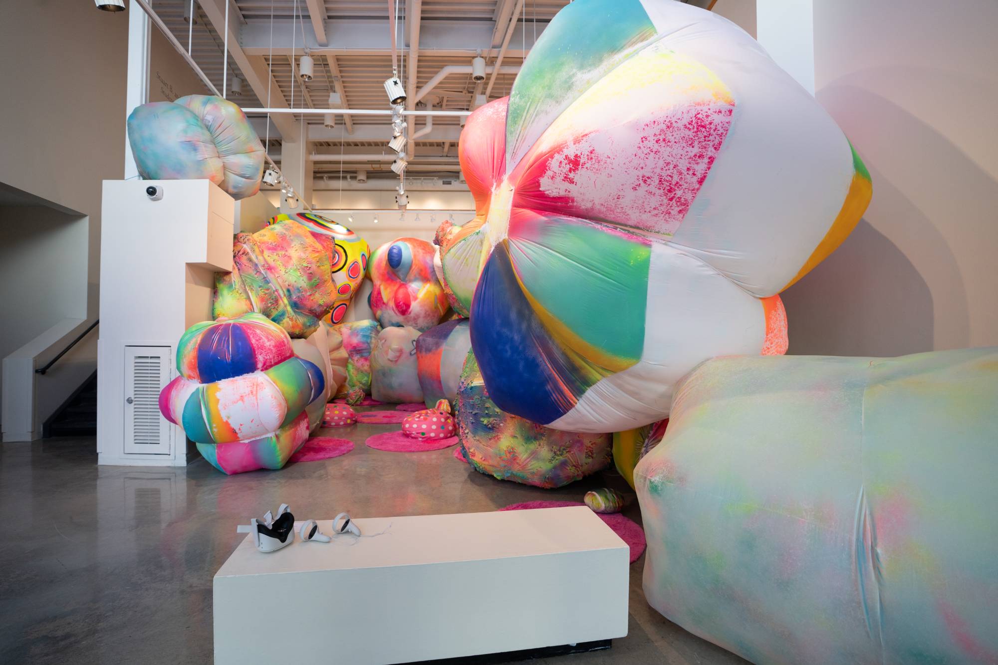 Brightly colored neon art installation in white-walled space.